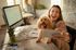 Happy entrepreneur taking a selfie with her dog while working from home office