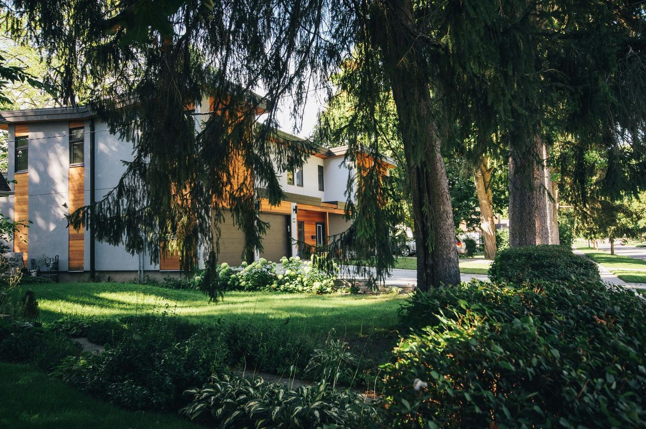 A house with a lot of trees in front of it