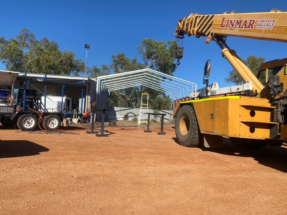 A Crane Lifting a White Metal Frame — Lincoln Fabrication in Burketown, QLD