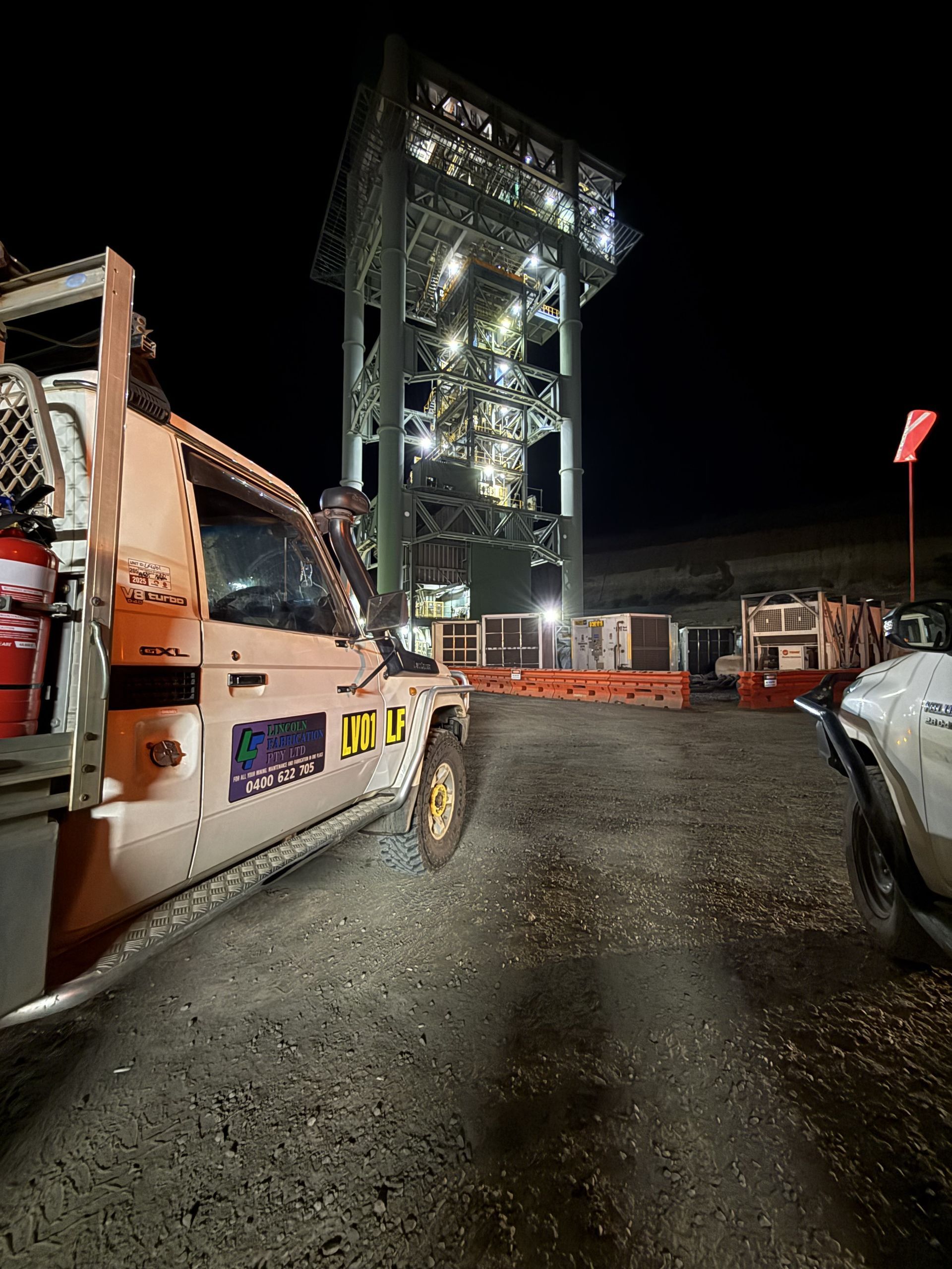 Work Truck in Foreground, Lit-up Industrial Tower — Lincoln Fabrication in Miles End, QLD