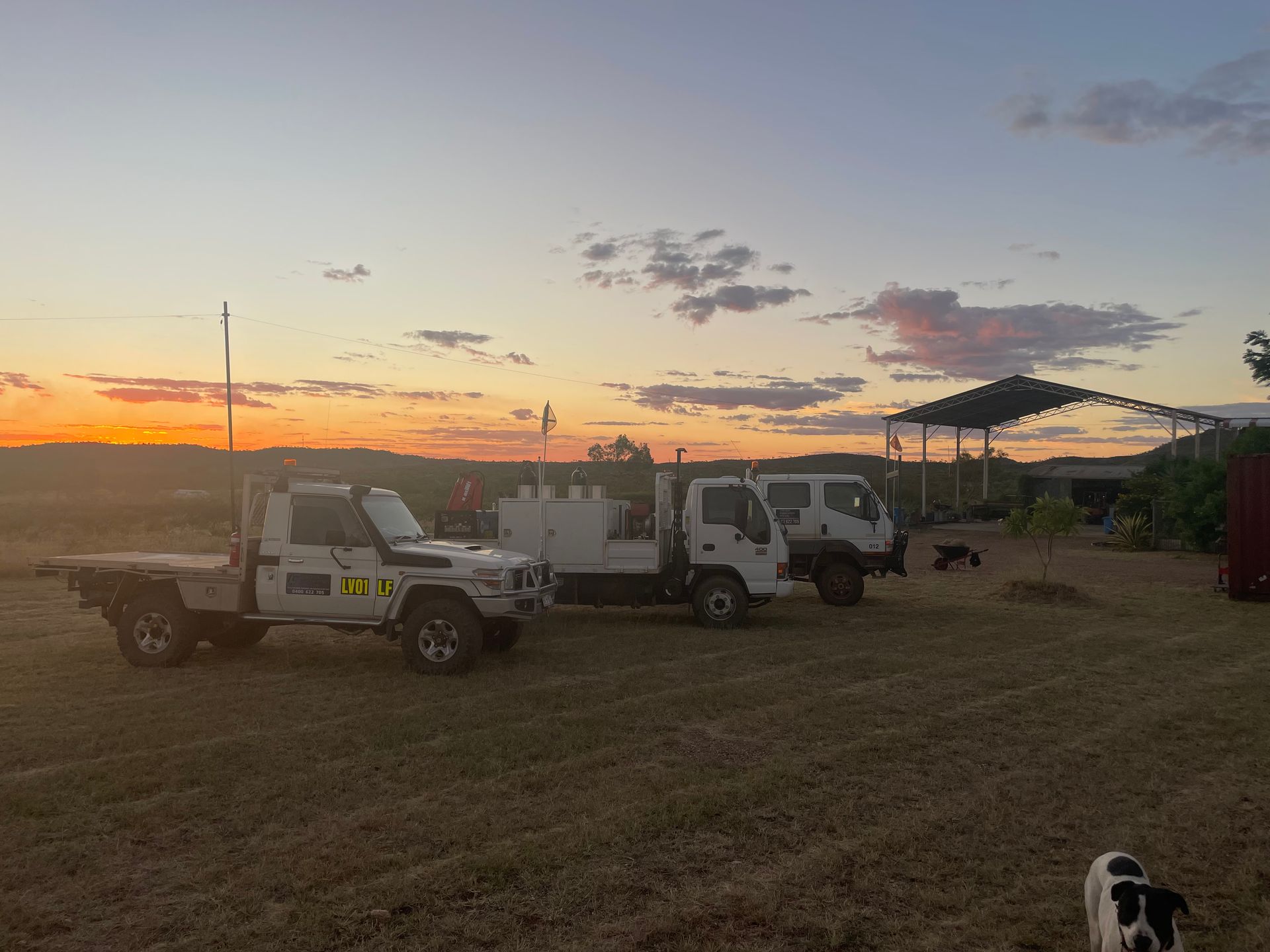 Three Work Trucks Parked in a Field at Sunset — Lincoln Fabrication in Miles End, QLD