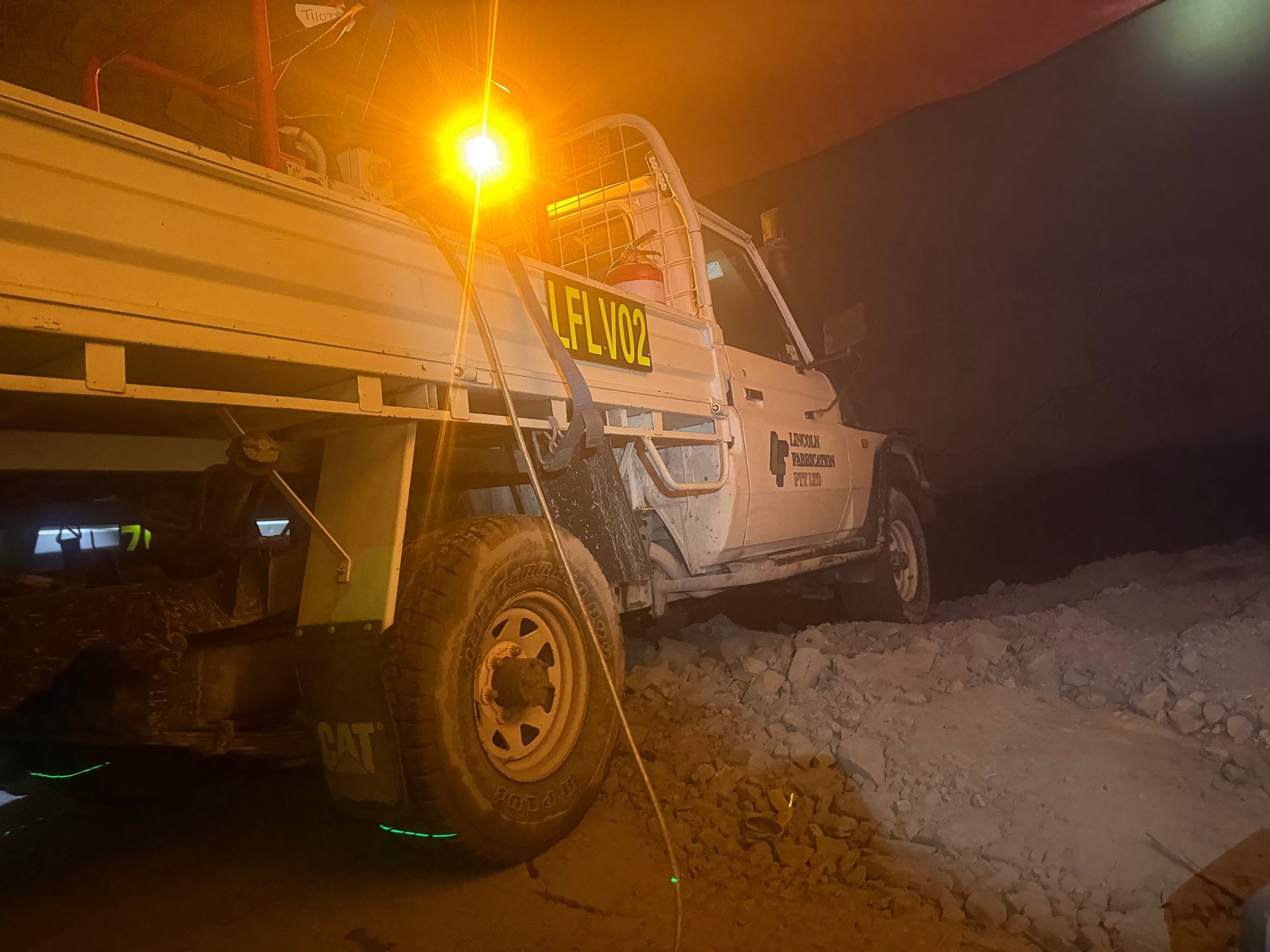 White Truck With Flatbed Stuck in Mud at Night — Lincoln Fabrication in Miles End, QLD