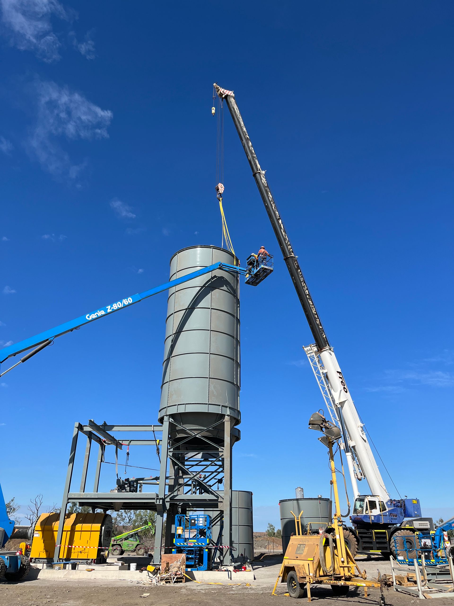 Crane Lifting a Metal Canopy Frame Over Gas Pumps — Lincoln Fabrication in Miles End, QLD