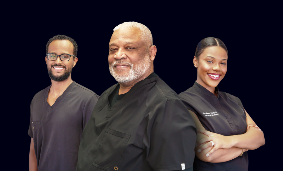 Dr. Davis  in a suit and tie stands in front of a family dentistry