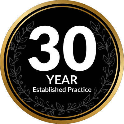 Black and gold circular emblem marking a 30 year established practice. Large white