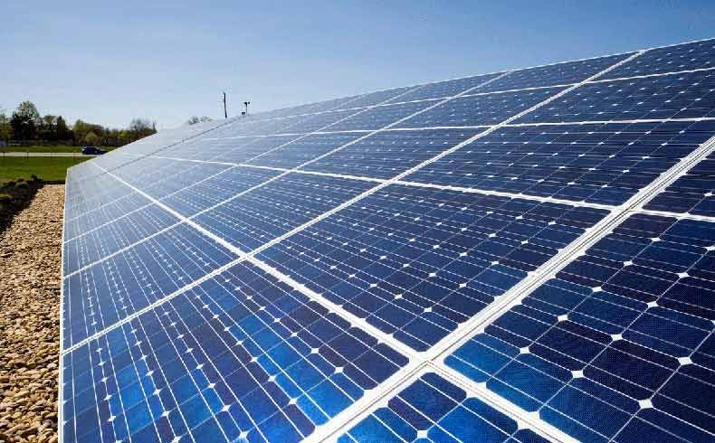 A row of solar panels against a blue sky