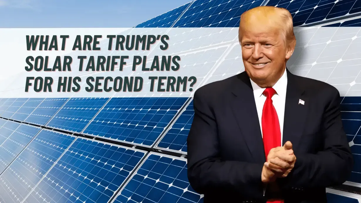 A man in a suit and tie is standing in front of solar panels.