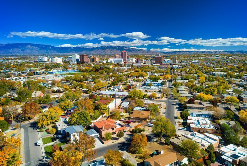 An aerial view of a city with mountains in the background. An aerial view of a city with mountains in the background.