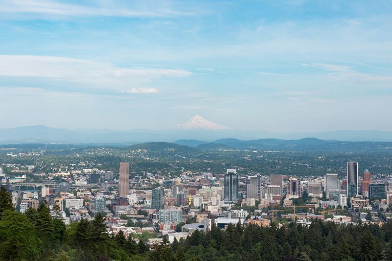 An aerial view of a city with mountains in the background.