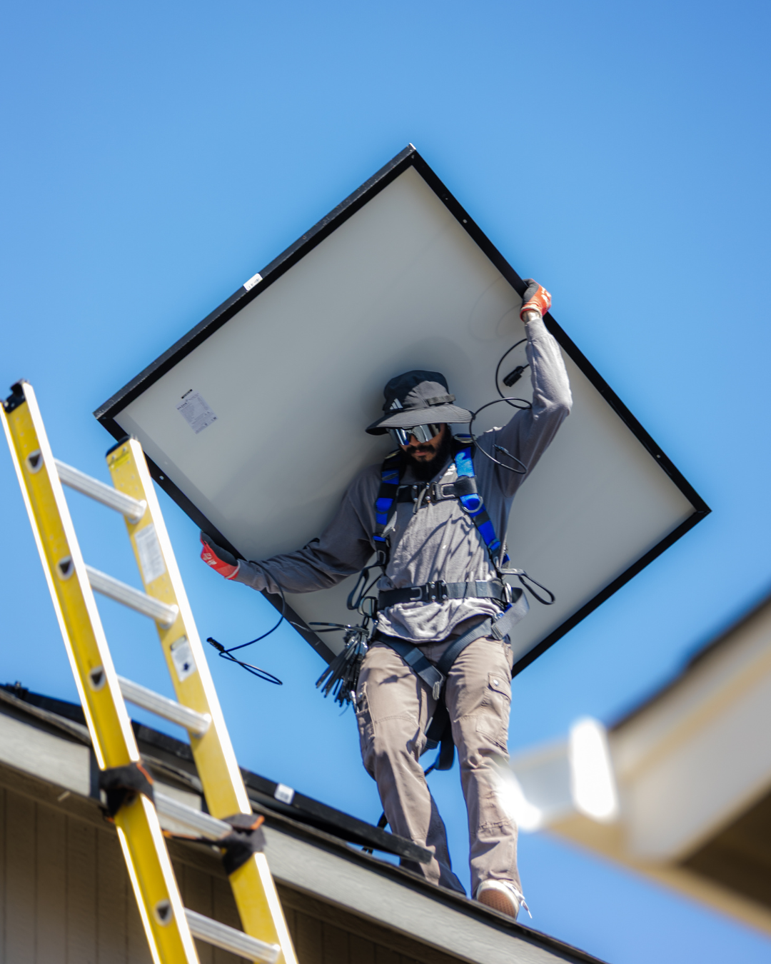 An aerial view of a house in the middle of a forest surrounded by trees.