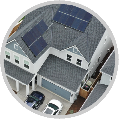 An aerial view of a house with solar panels on the roof An aerial view of a house with solar panels on the roof