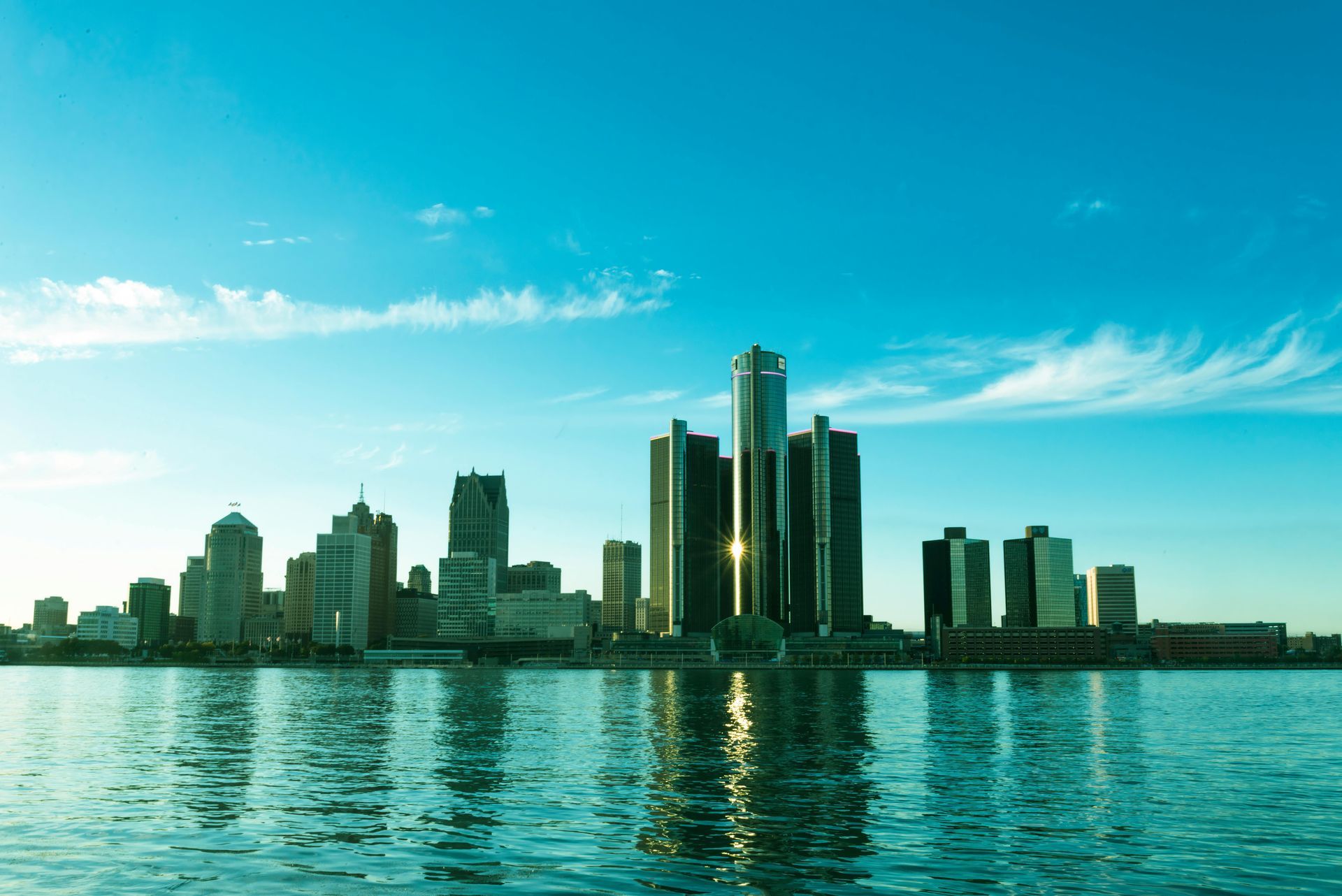 The skyline of New Jersey is reflected in a lake.