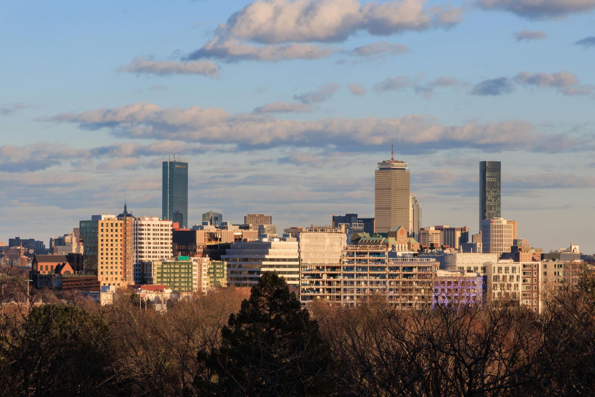 The skyline of New Jersey is reflected in a lake.