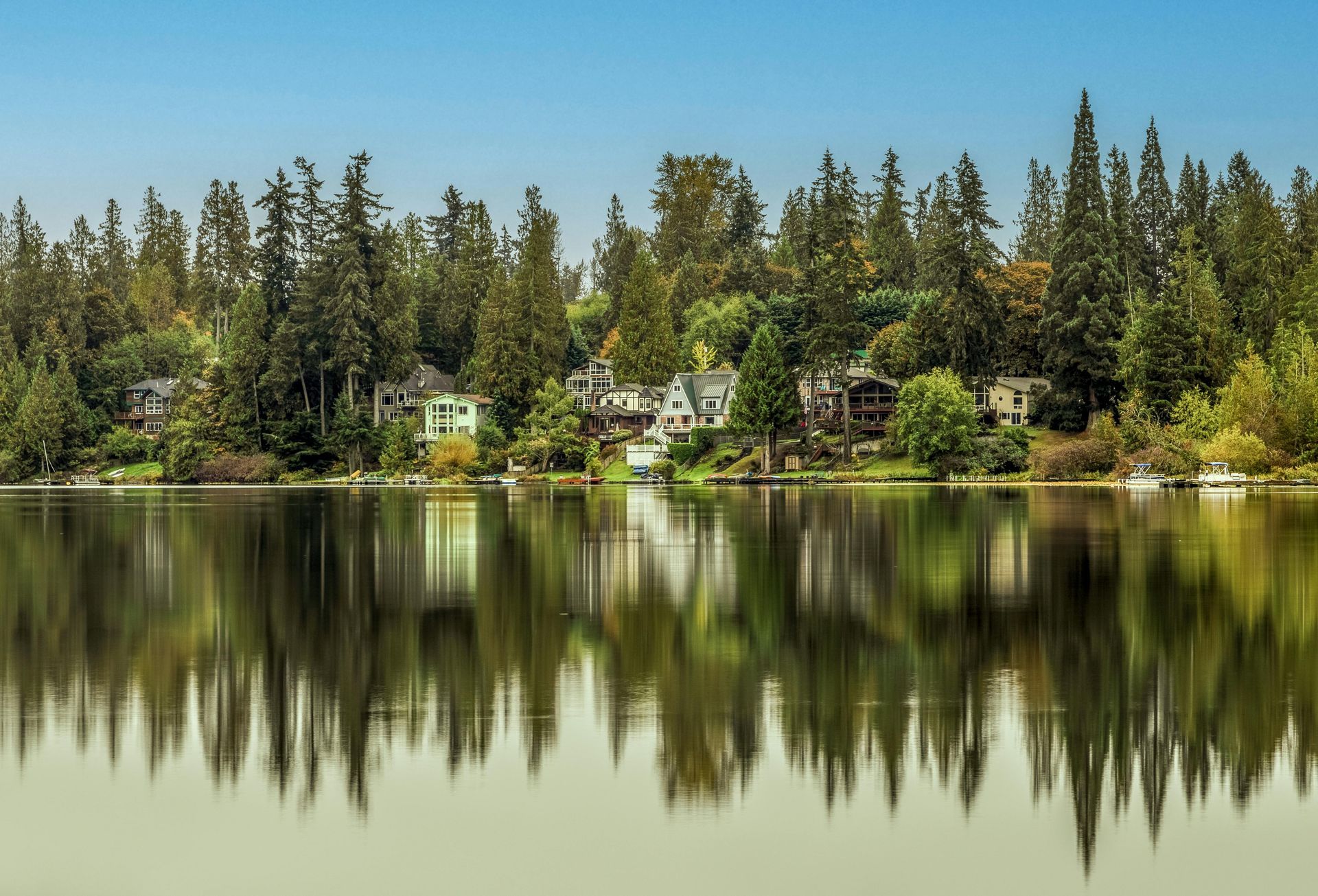The skyline of New Jersey is reflected in a lake.