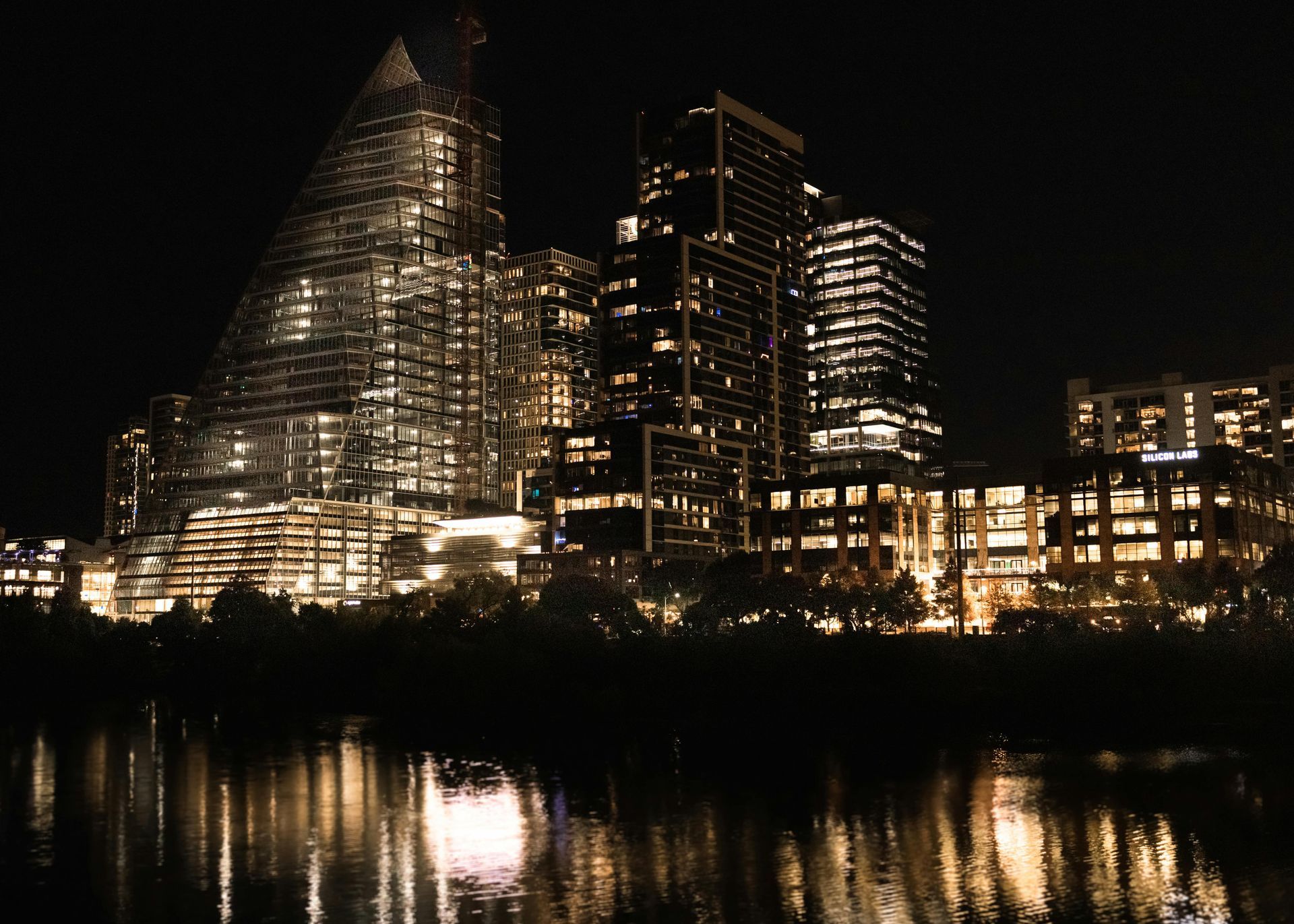 The skyline of New Jersey is reflected in a lake.