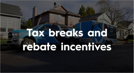 A blue truck with a trailer attached to it is parked in front of a house.