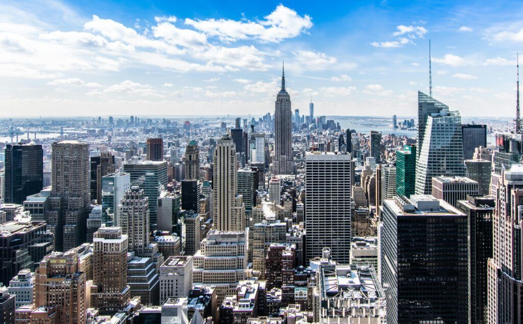 An aerial view of the skyline of New York City on a sunny day.
