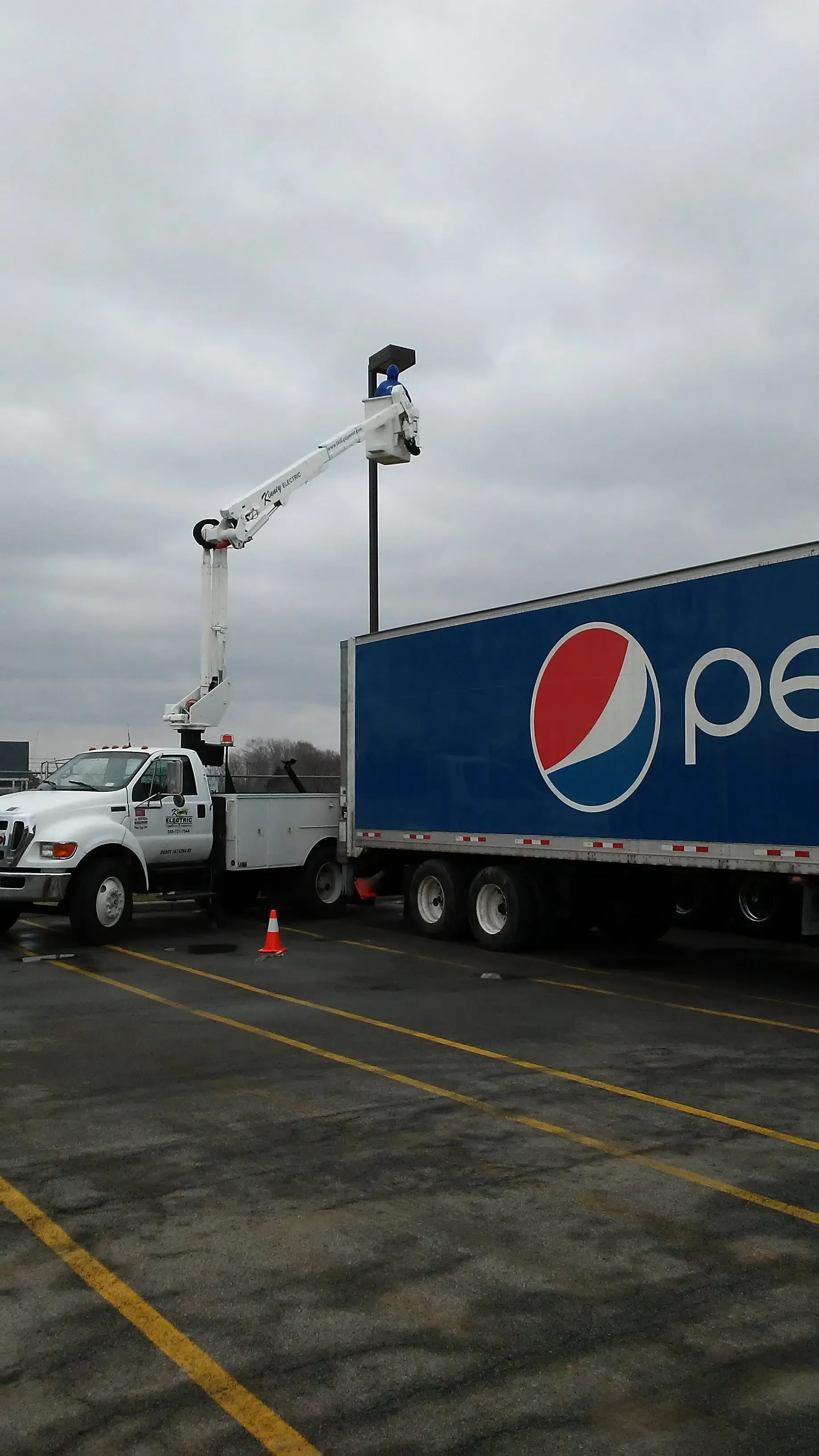 A pepsi truck is parked in a parking lot