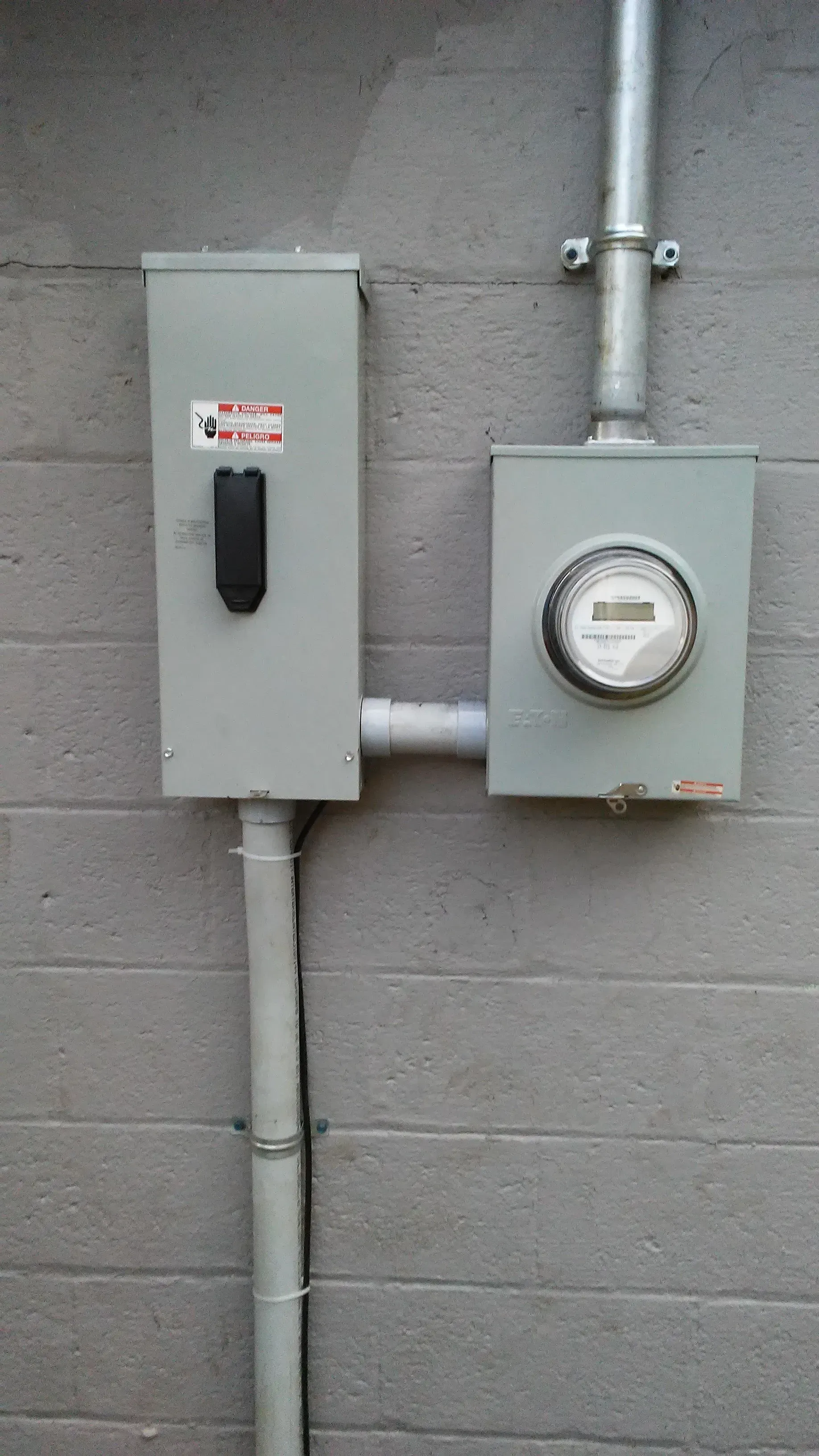 There is a meter on the side of a building.