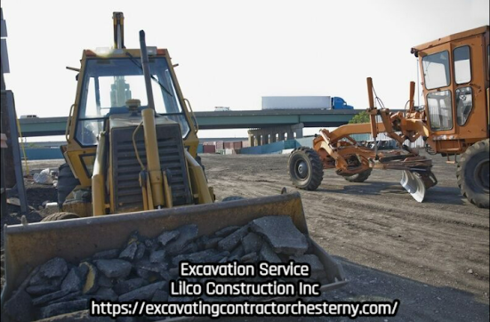 Construction site with yellow bulldozer, orange grader, and highway overpass in background.