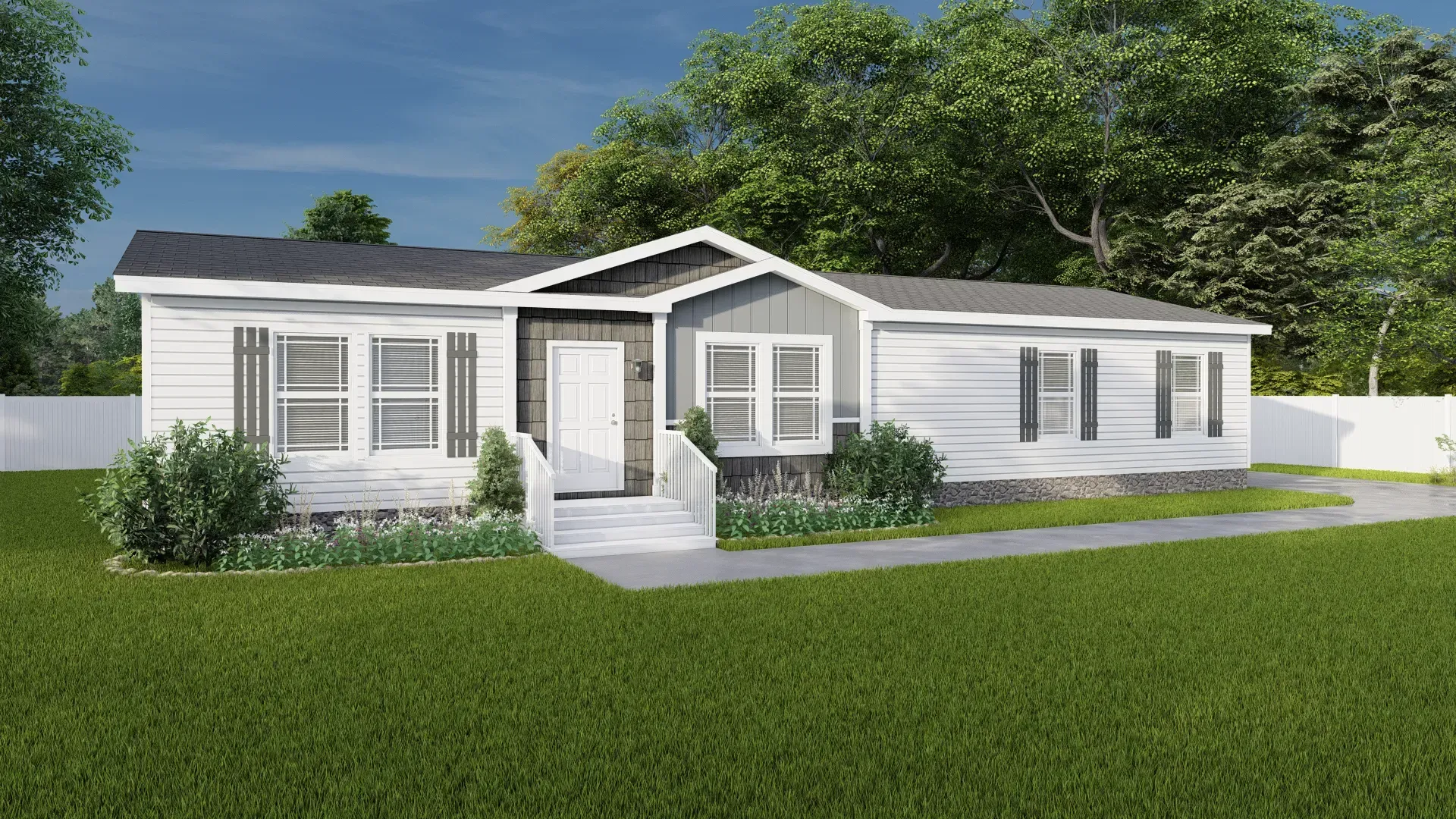 A white mobile home with a gray roof is sitting on top of a lush green lawn.