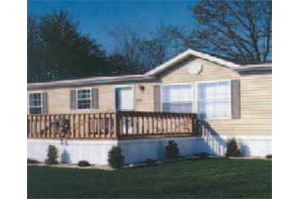 A mobile home with a large deck and stairs