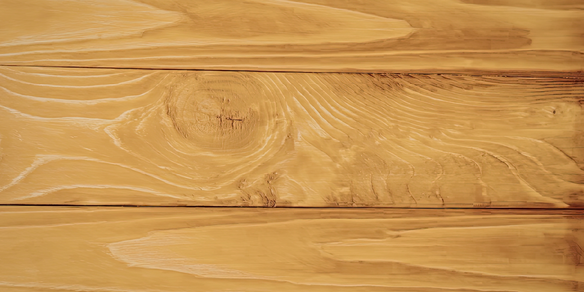 A close-up view of light brown wooden planks with a prominent knot and natural wood grain patterns.
