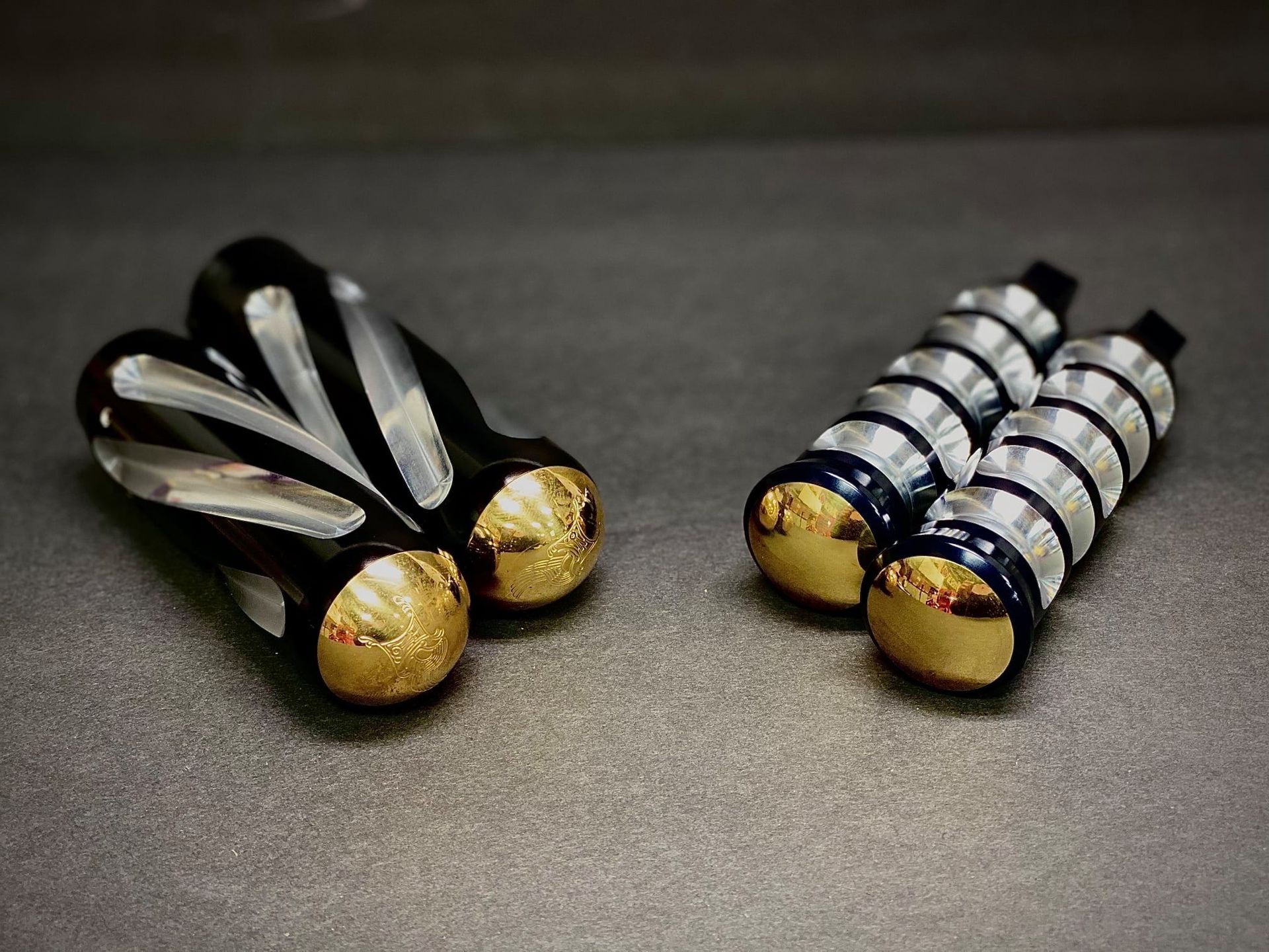 A pair of black and gold earrings are sitting next to each other on a table.