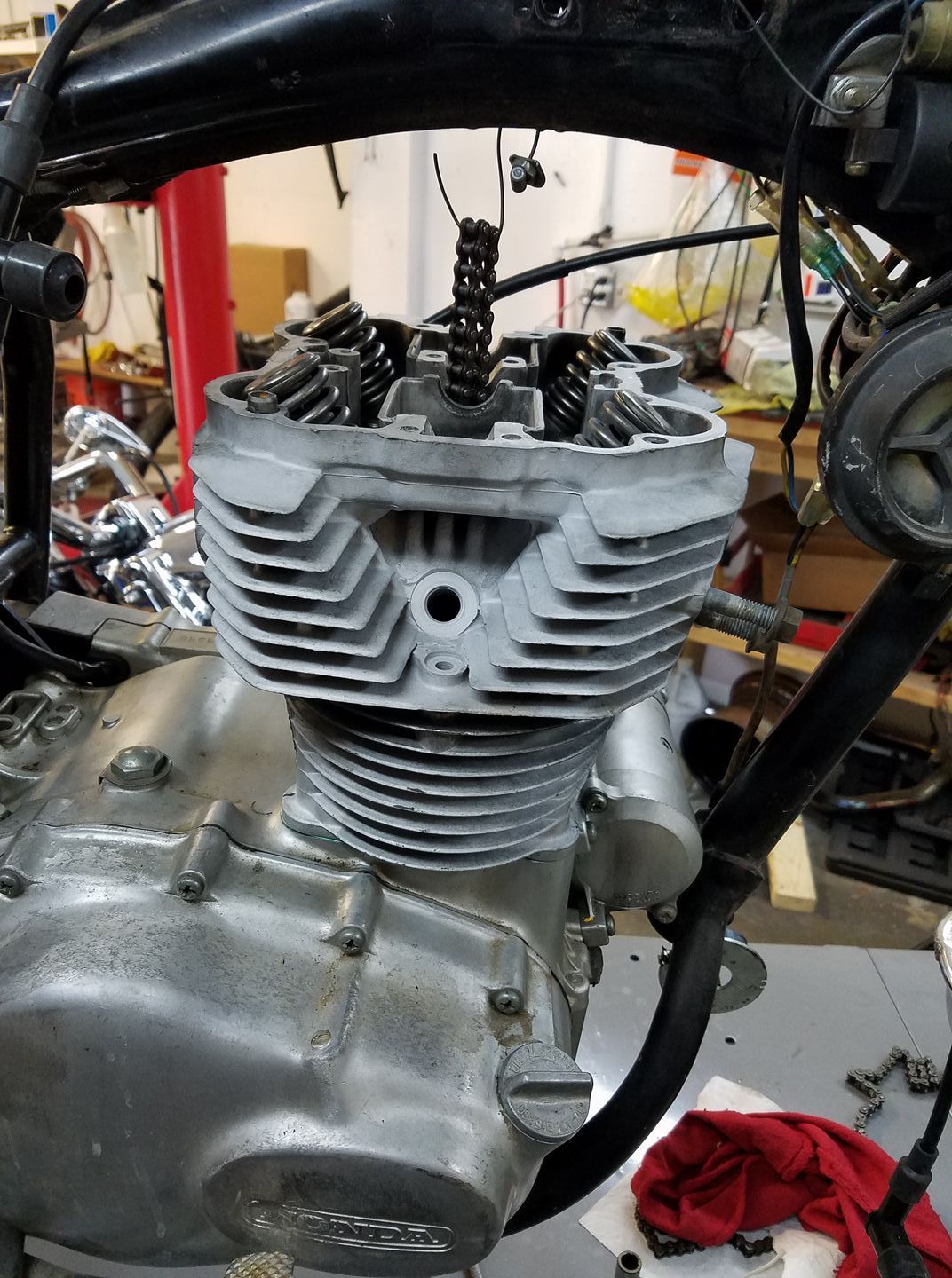 A motorcycle engine is being worked on in a garage