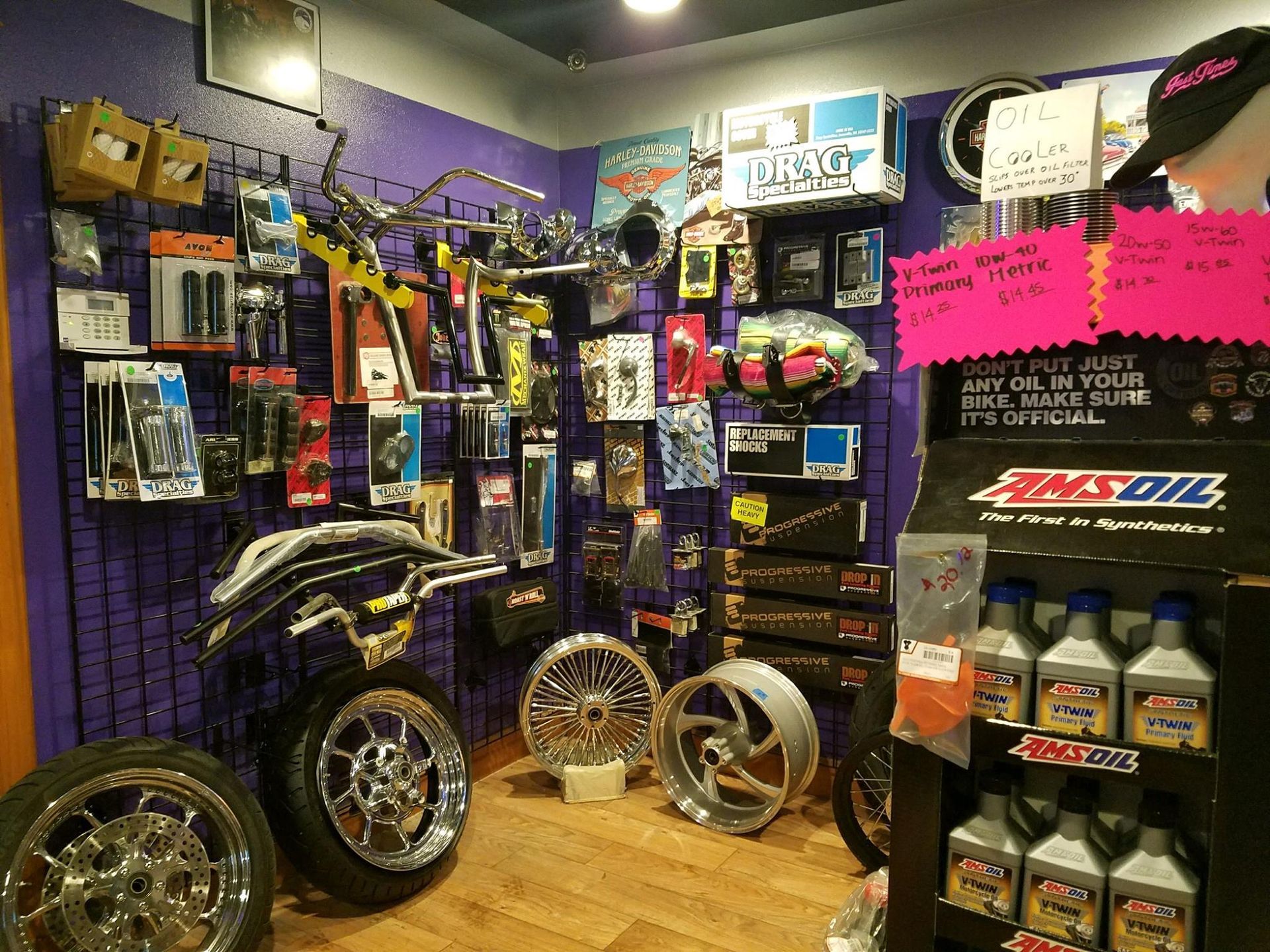 A motorcycle parts store with a display of amsoil oil