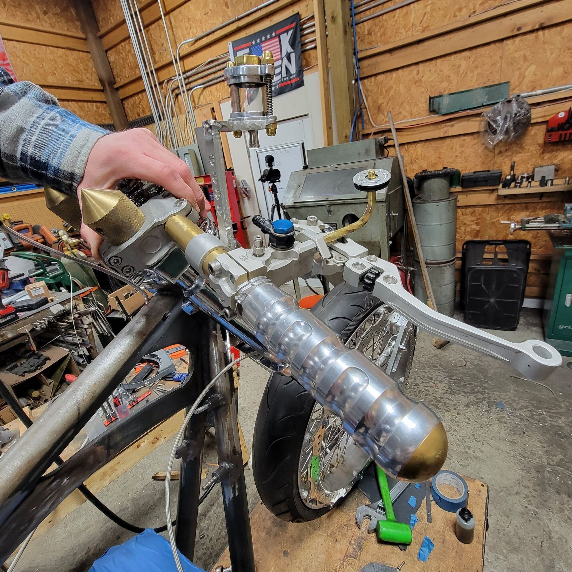 A person is working on a motorcycle in a garage