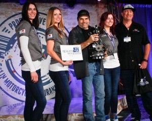 A group of people standing next to each other holding a trophy.