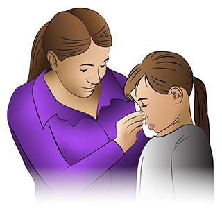 A person in a purple shirt uses their hand to gently pinch the bridge of a child's nose.