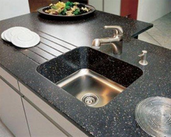 A kitchen counter with a sink and a plate of food on it