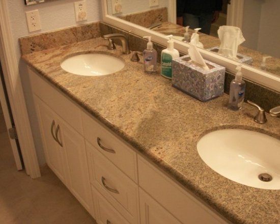 A bathroom with two sinks and a mirror.