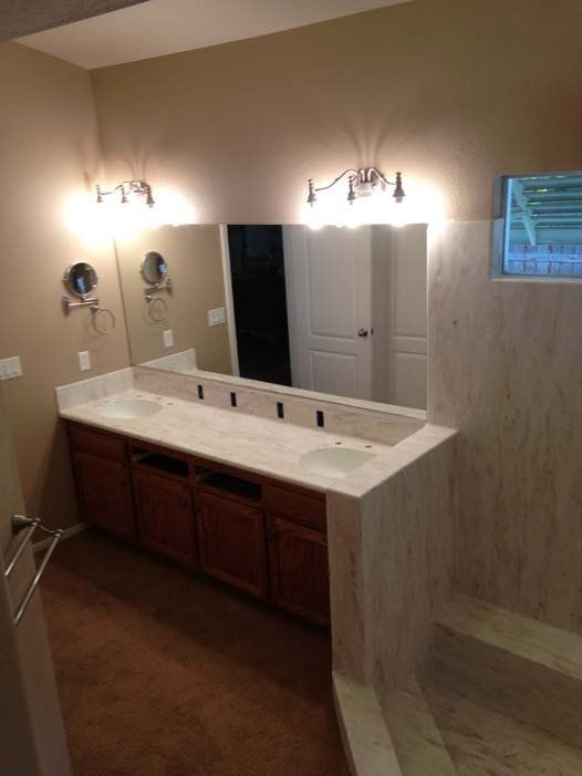 A bathroom with two sinks and a large mirror