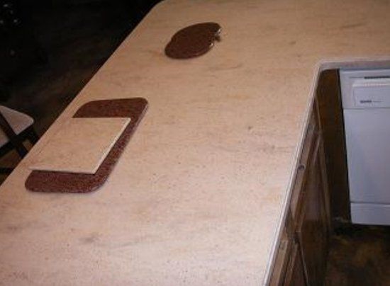 A marble counter top with a phone on it.