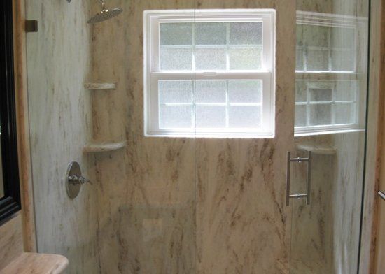 A bathroom with a shower and a window