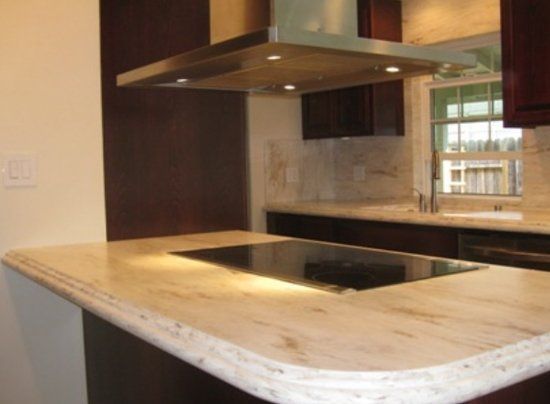 A kitchen with a stove top oven and a window.