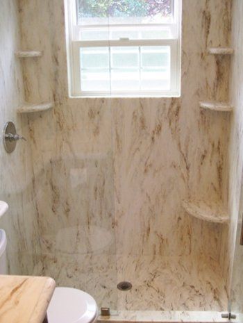 A bathroom with a shower , toilet , and window.