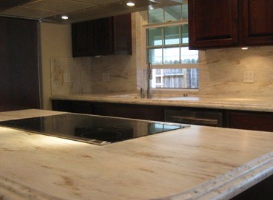A kitchen with a stove top oven and a sink