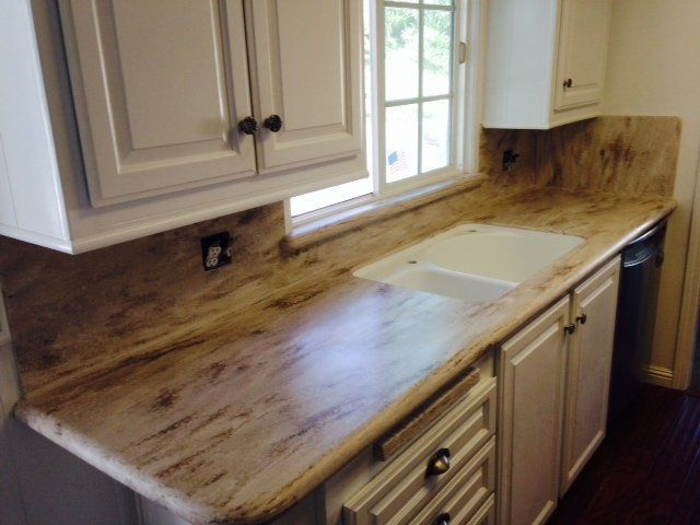 A kitchen with white cabinets and granite counter tops