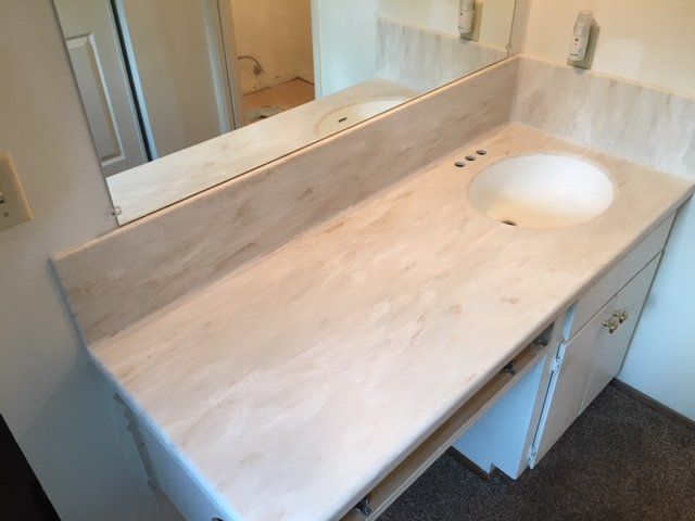 A bathroom counter with a sink and a mirror