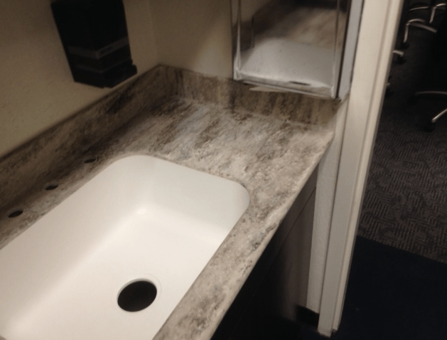 A bathroom sink with a hole in the middle of it.