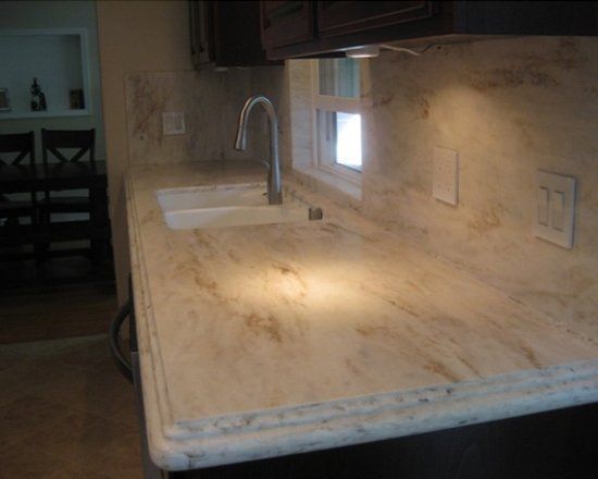 A kitchen counter with a sink and a window