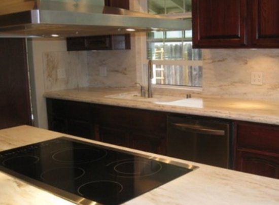 A kitchen with a stove top oven and a sink