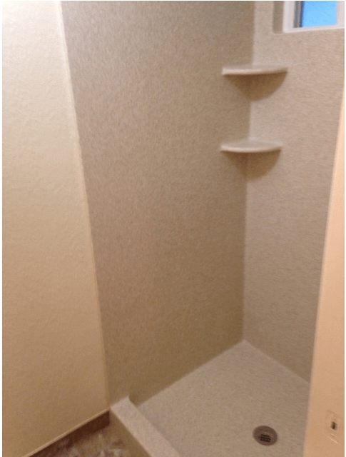 A shower stall with shelves and a window in a bathroom