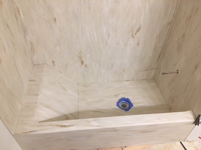 A bathroom with a bathtub and a shower stall.