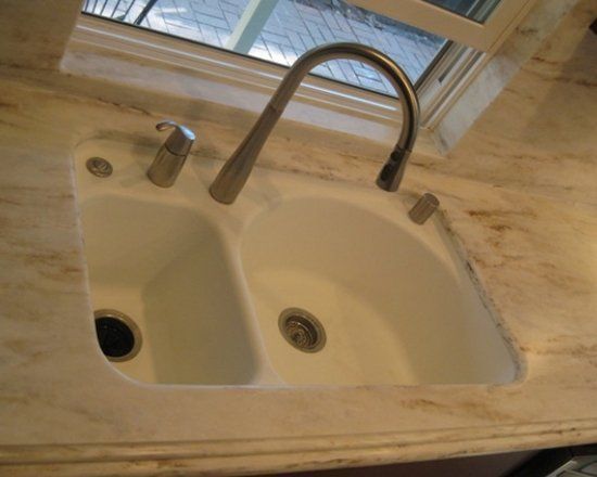 A kitchen sink with a window in the background