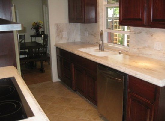 A kitchen with stainless steel appliances and wooden cabinets